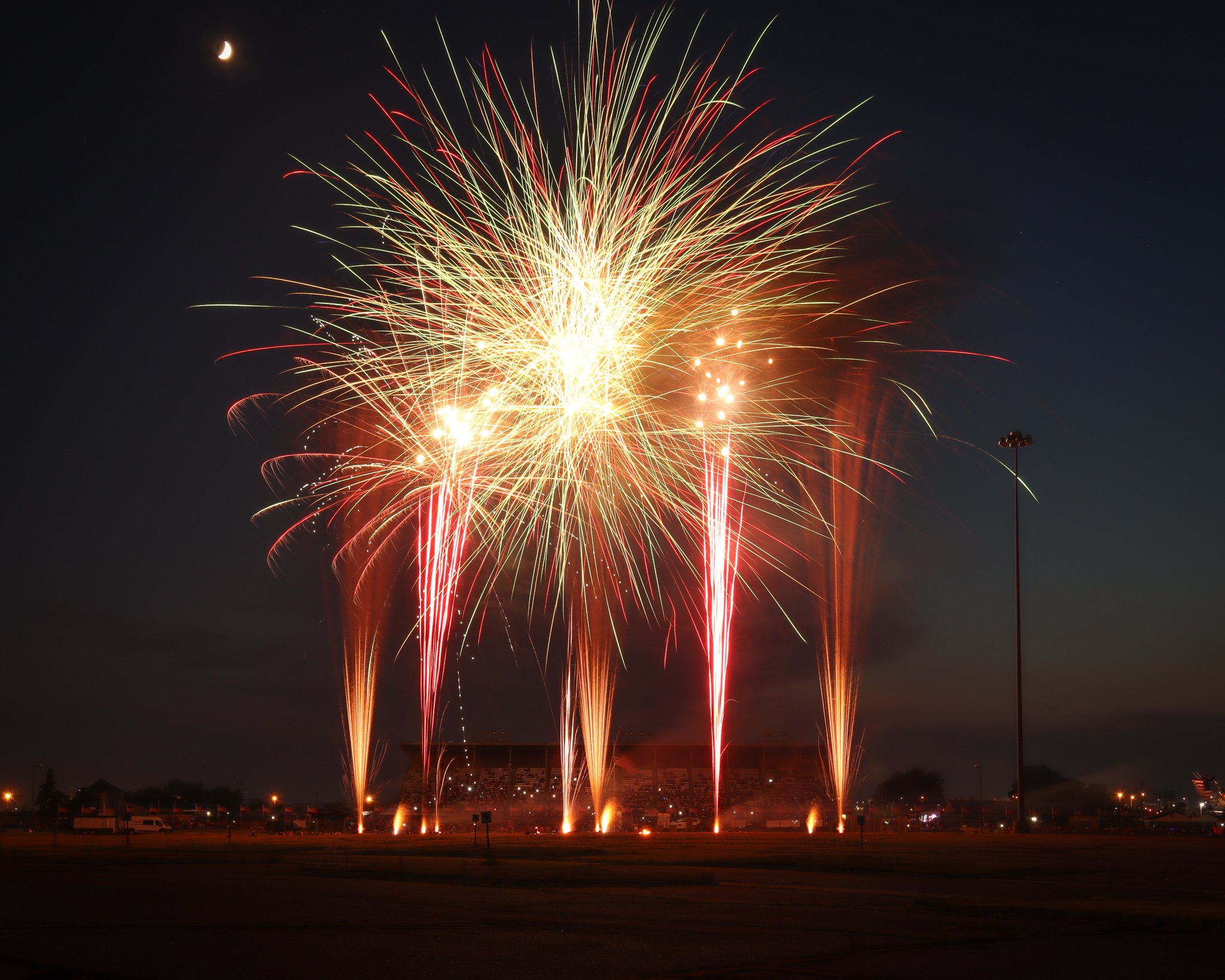 Golden fireworks bloom across the night sky